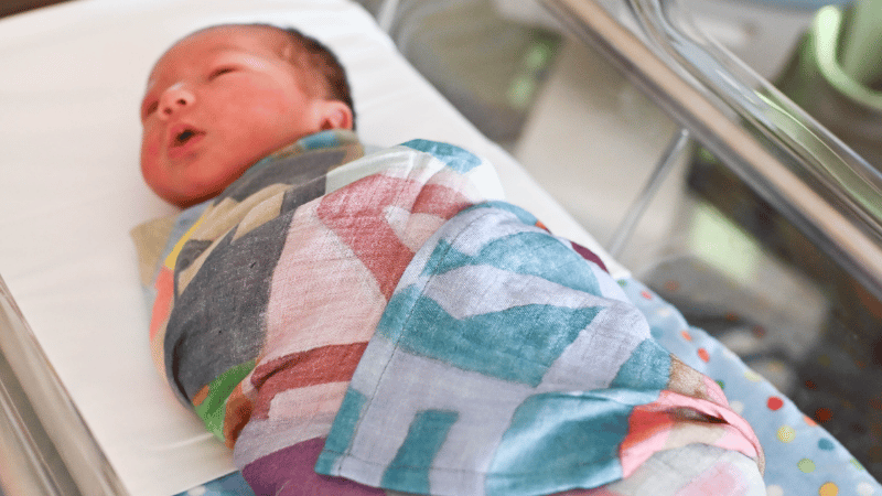 A baby in a swaddle blanket at East Alabama Medical Center.