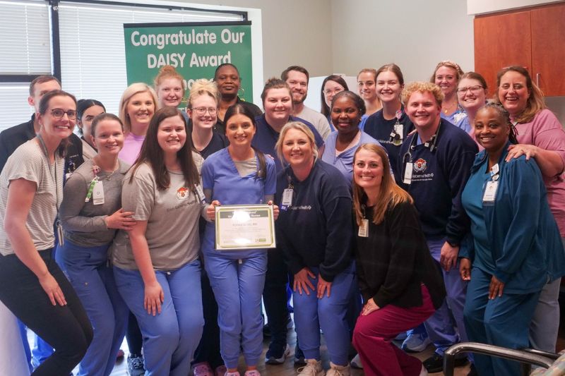 Karlee Smith, a nurse at EAMC, poses with other staff members after receiving a DAISY Award.