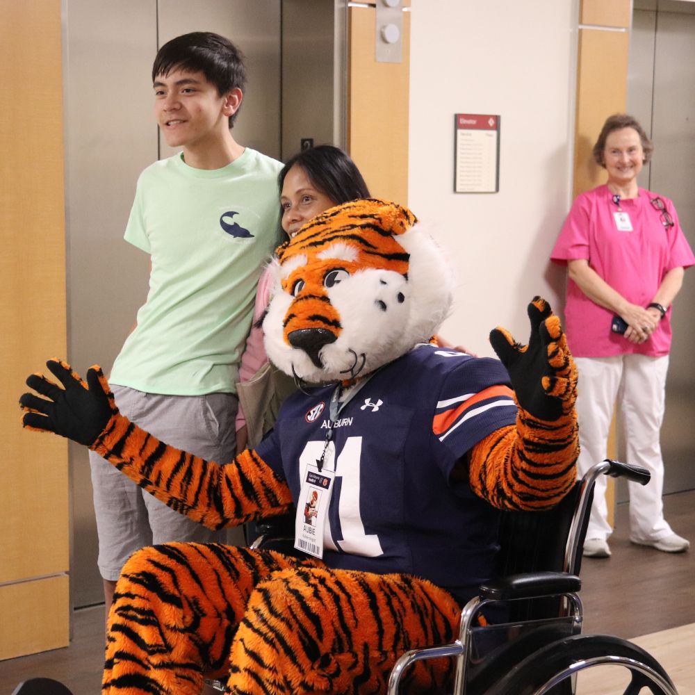 Aubie the Tiger poses for a photo with fans while visiting East Alabama Medical Center.