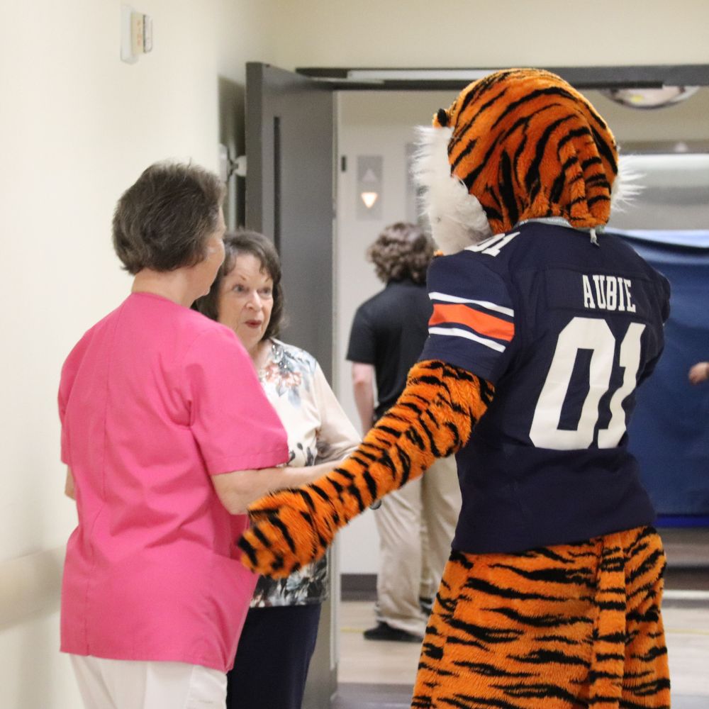 Volunteers at East Alabama Medical Center catch up with Aubie the Tiger. 