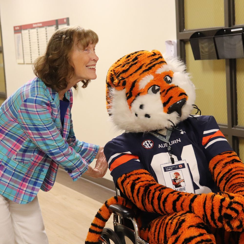 Aubie the Tiger and a visitor at East Alabama Medical Center pose for a photo. 